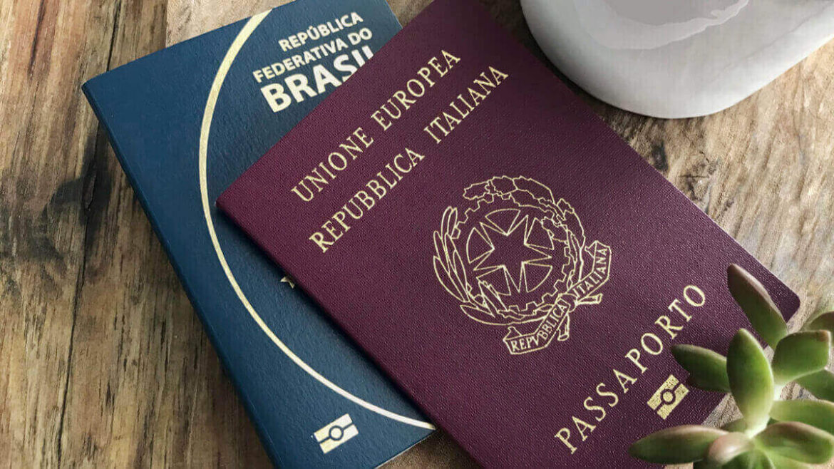 Passaporte italiano sobre passaporte brasileiro em mesa de madeira com planta ao lado