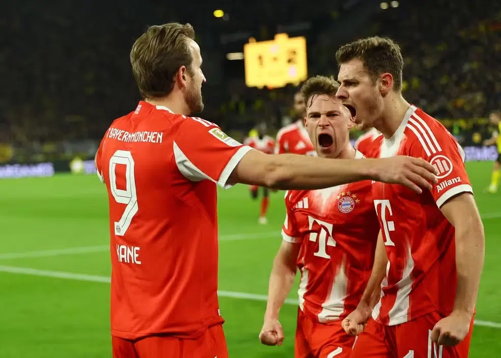 Futebol hoje: Descubra quem joga e onde assistir ao vivo – 10/03/2026 6 Jogadores de futebol com uniforme vermelho comemoram gol juntos no gramado