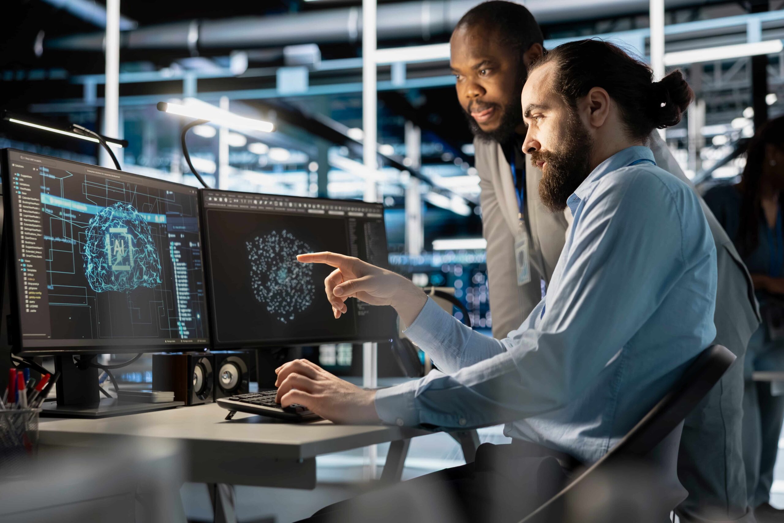Quanto ganham os funcionários do Instagram e Facebook? Veja os salários da Meta 6 Dois profissionais de TI apontam para monitores exibindo gráficos de IA em ambiente corporativo moderno